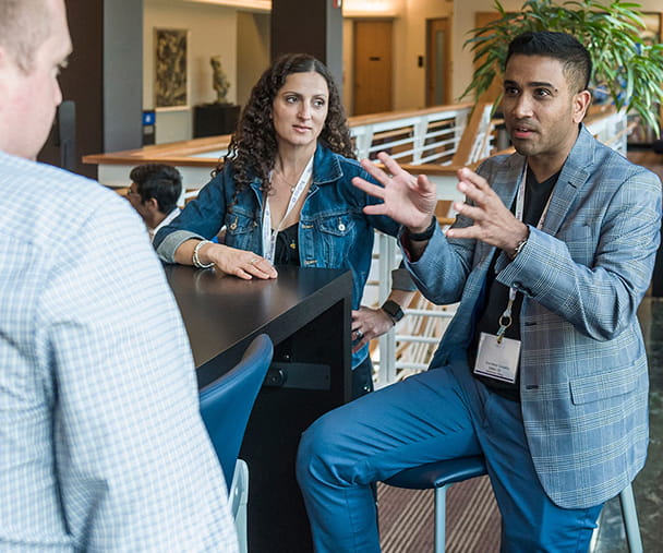 A group of Kellogg Executive MBA students in conversation together at the Allen Center